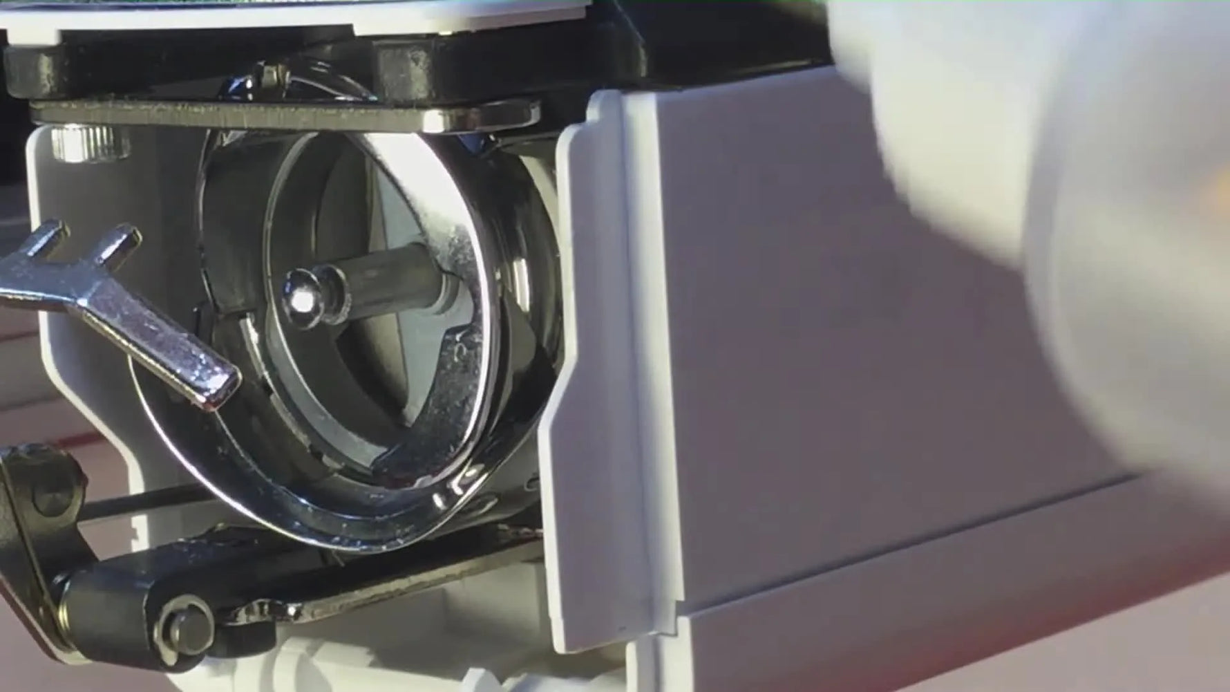 A precision oiler places a single drop of oil into the Brother PR1055X rotary hook race at the correct contact point.