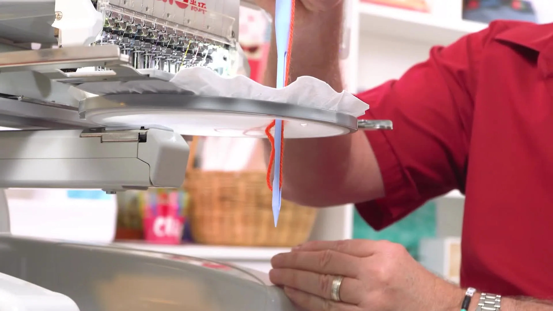 A close-up shows the thread loop ballooning on the scarf side of a round-shank needle—exactly what the rotary hook must catch to form a clean stitch.