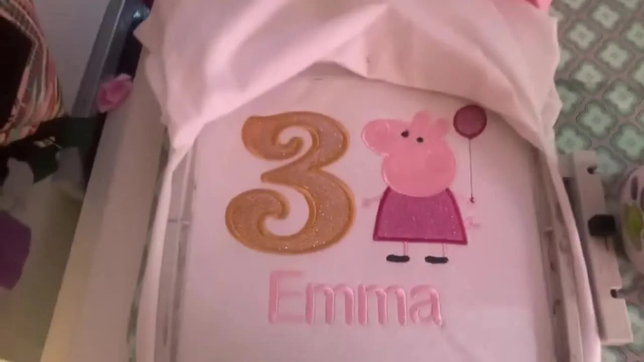 A finished Peppa Pig–themed birthday shirt remains in the Janome hoop, showing a gold glitter number and personalized name.