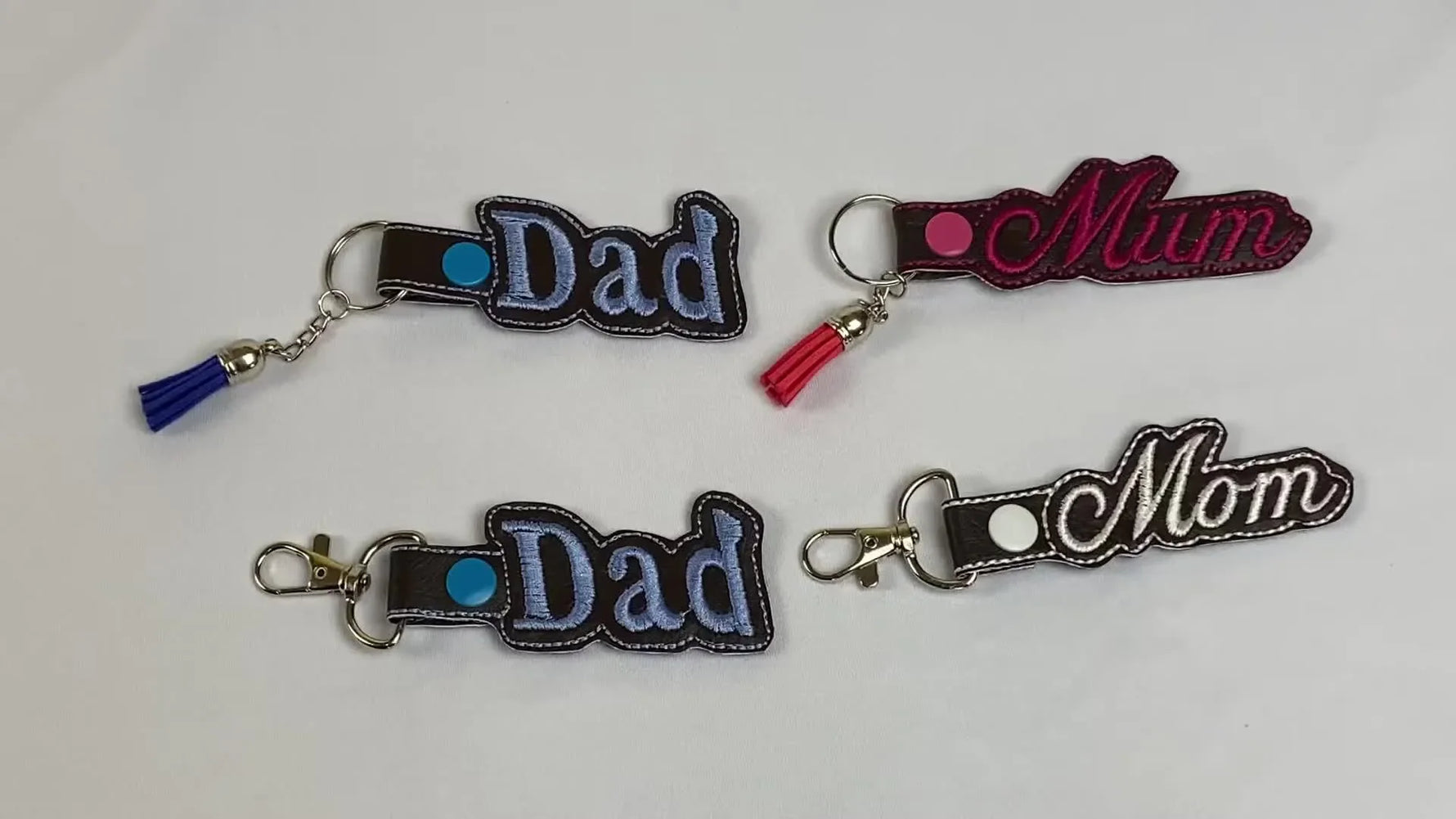Four completed 'Dad' and 'Mum' key fobs on a white background, demonstrating the final products.