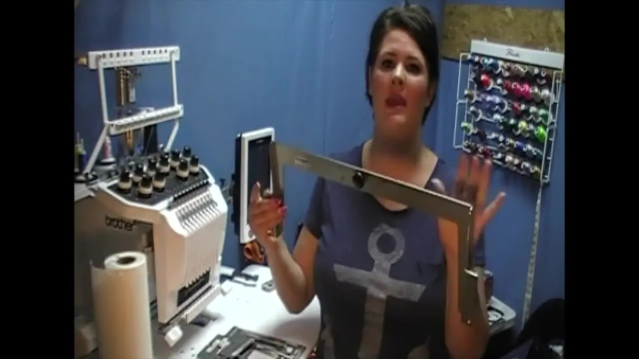 Whitney holds the Fast Frames mounting bracket bar used to attach hoopless frames to Brother multi-needle machines.