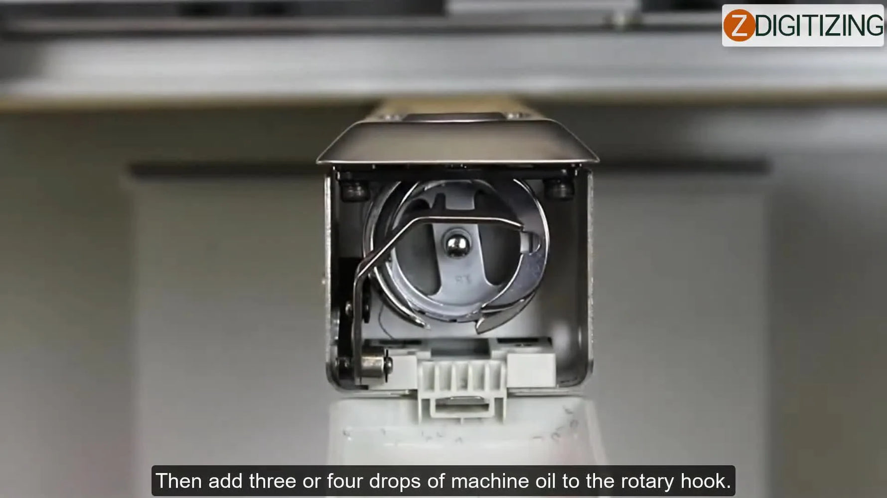 A close-up shows a precision oiler applying a few drops of oil into the Ricoma TC-1501 rotary hook area.