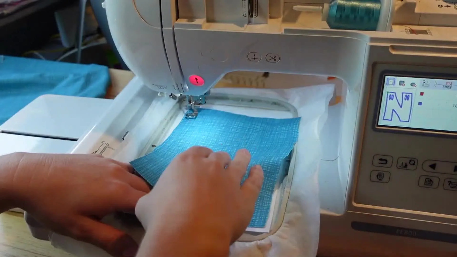 A rope basket decorated with a finished KNOX fabric letter banner, showing the final double-sided freestanding applique look.