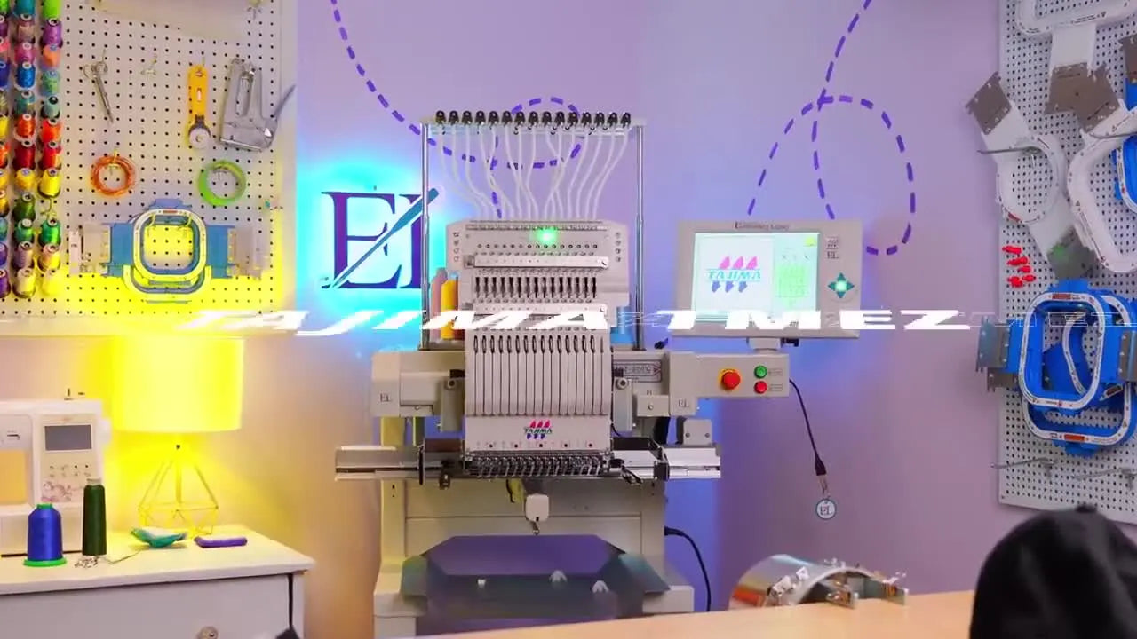 A full front view of the Tajima TMEZ machine set up in a studio, ready for commercial embroidery production.