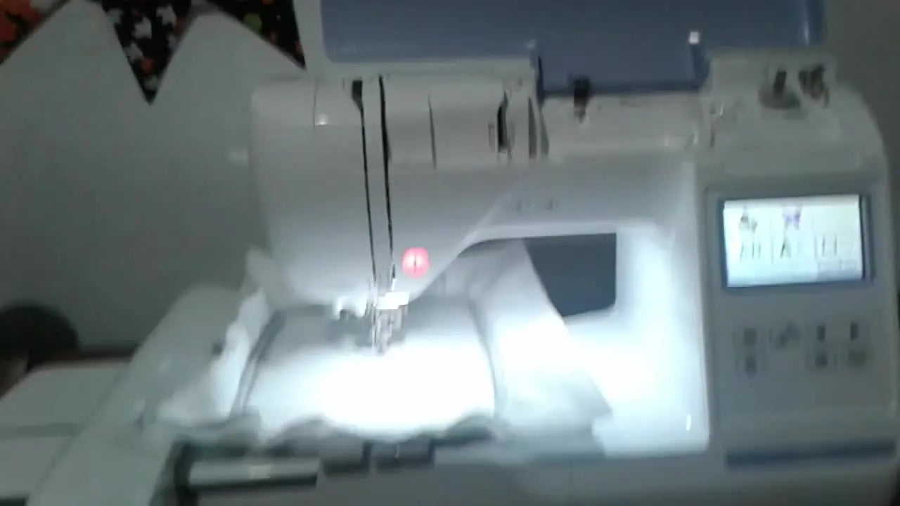 A powered-on Brother PE800 with the standard 5x7 hoop attached and stabilizer hooped tight, ready for a first stitch-out.