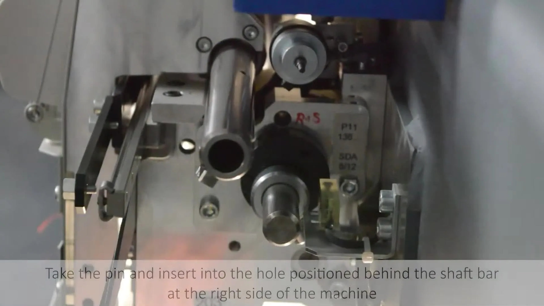 A close-up shows the ZSK timing pin sliding into the alignment block, confirming the machine is locked at the correct timing position.