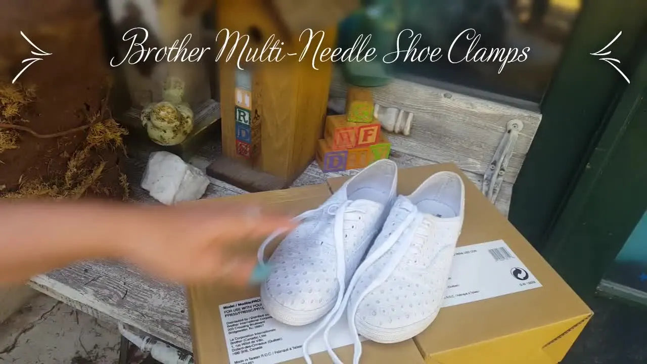 A Brother PR-series multi-needle machine stitches a small monogram on a white canvas sneaker held rigidly in a metal shoe clamp.