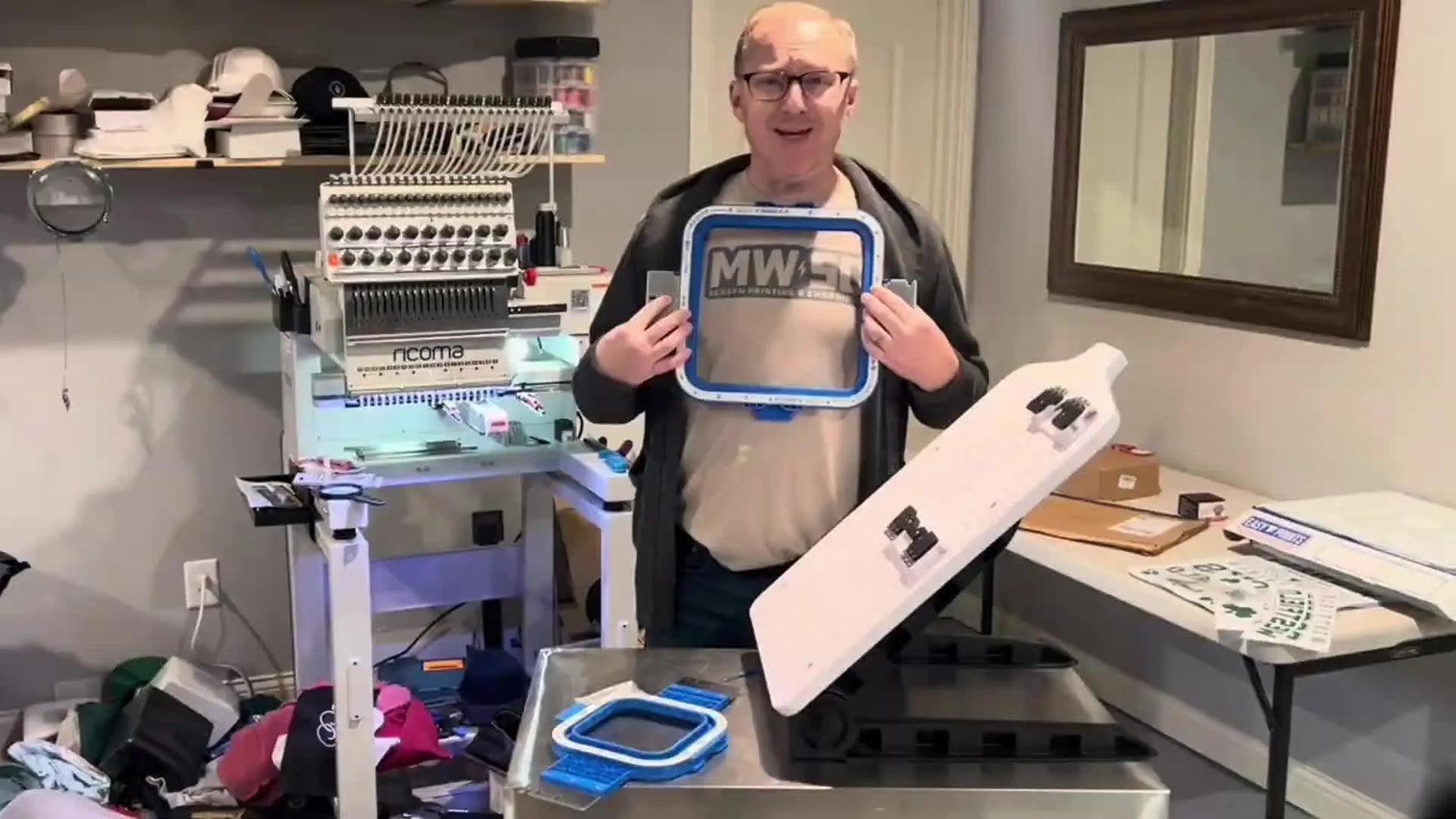 The presenter holds the large Sewtalent 9.5x9.5 magnetic hoop, introducing it as a sturdy placement-friendly option for commercial embroidery workflows.