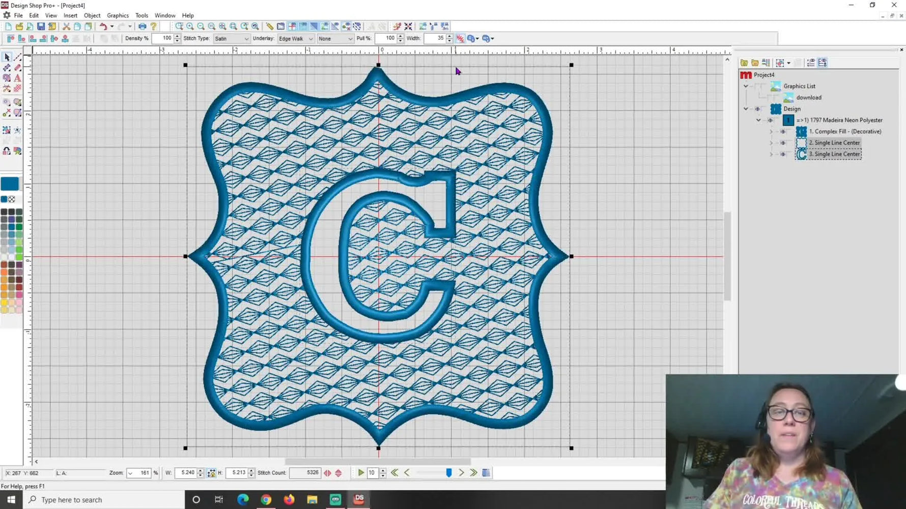 The finished Design Shop layout shows a decorative knockdown background with a negative-space “C” and a bold satin border ready for towel stitch-out.