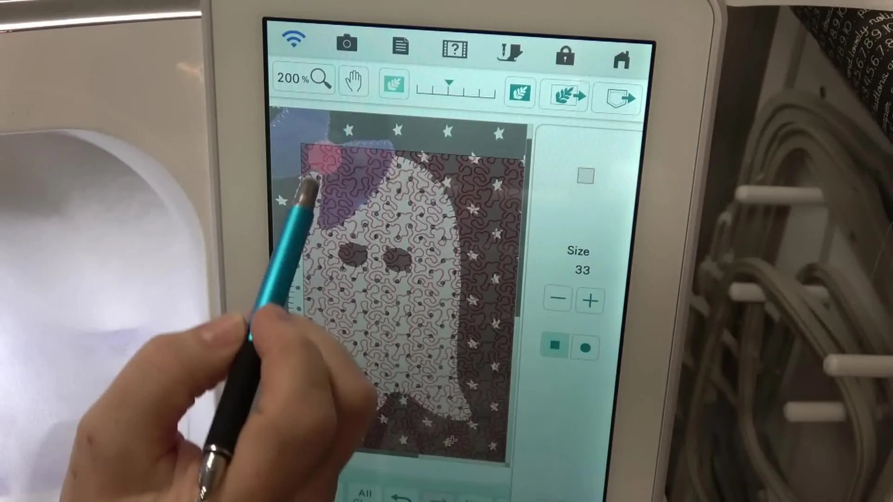 A close-up screen view shows the eraser tool removing stipple stitches so the quilting avoids the ghost appliqué perfectly.