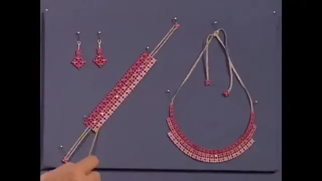 A finished free-standing lace jewelry set—necklace, bracelet, and earrings—displayed together to show the final look and structure.