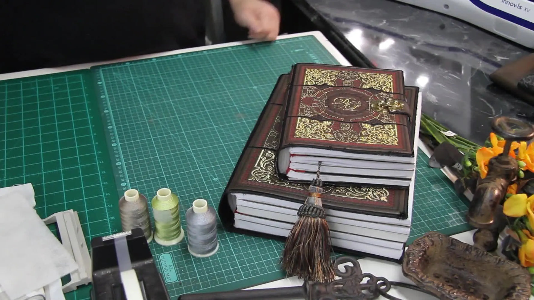 Finished embroidered book cover with a decorative metal clasp