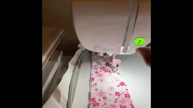 A close-up of the Brother Innov-is NQ1700E stitching the final perimeter line through the full ITH fabric-and-foam sandwich.