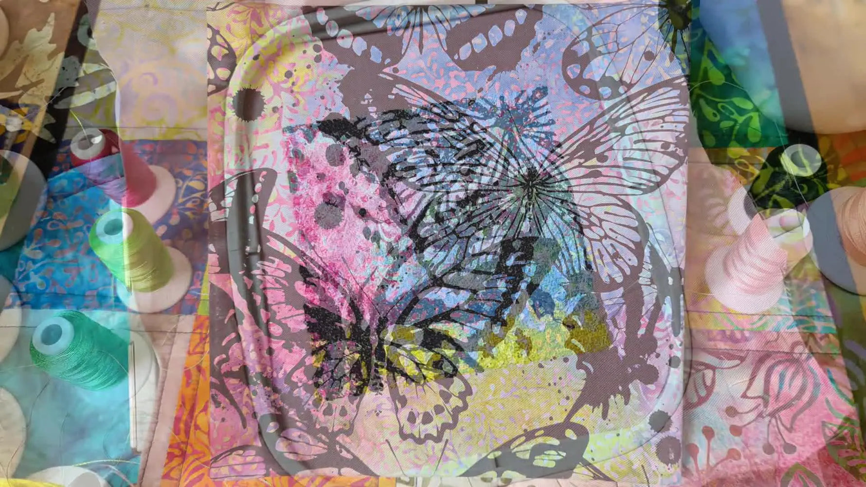 Finished embroidered butterfly design in a pink embroidery hoop, showcasing detailed stitching.