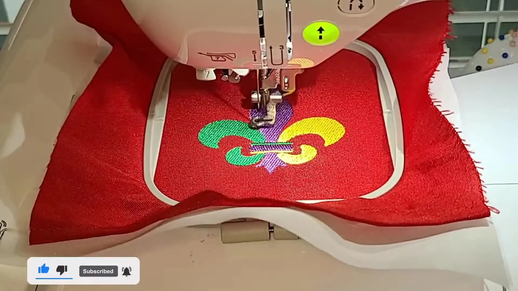 A close-up of the Brother SE1900 stitching the final gold band across a fully formed Mardi Gras Fleur de Lis design.
